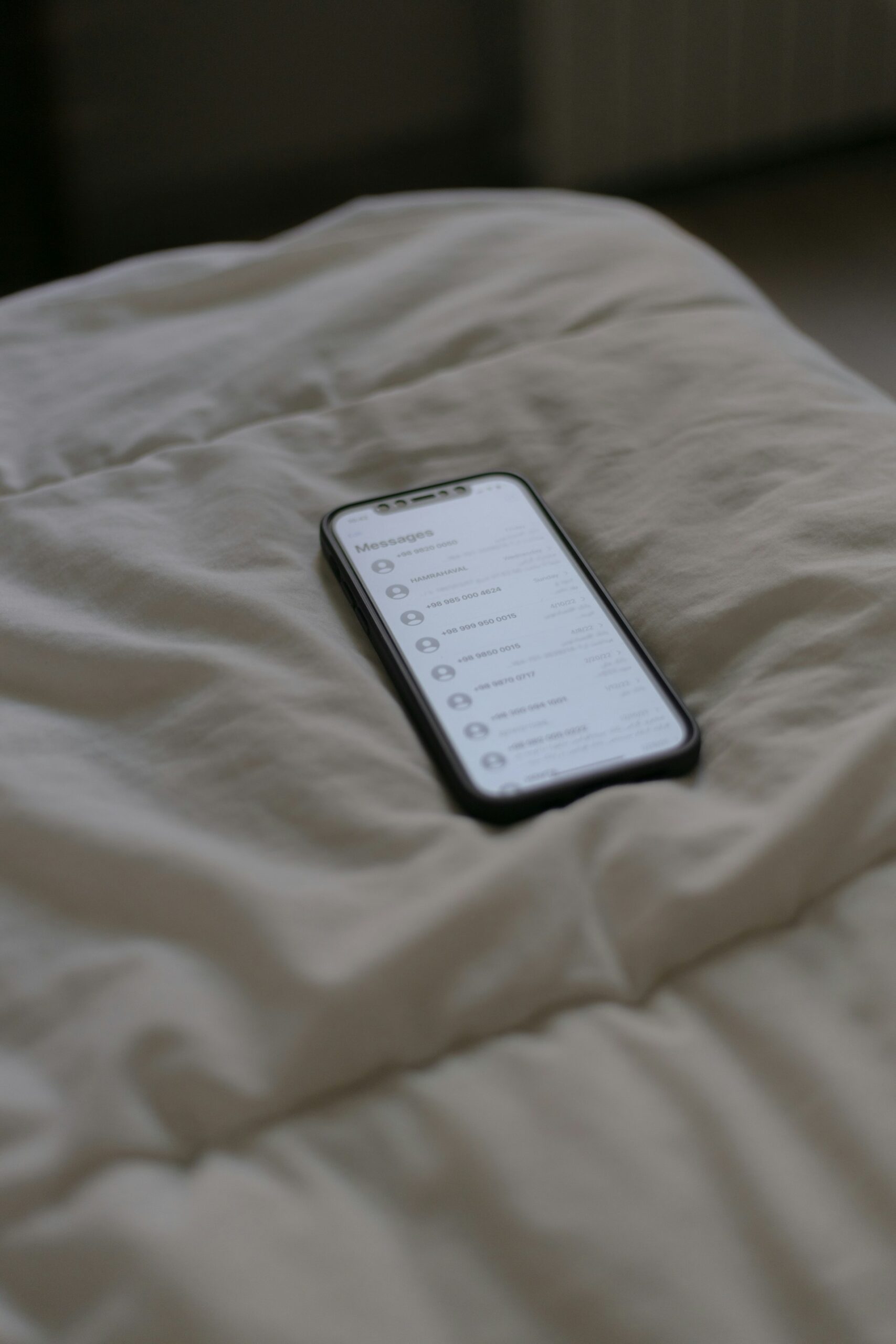 person using phone on bed